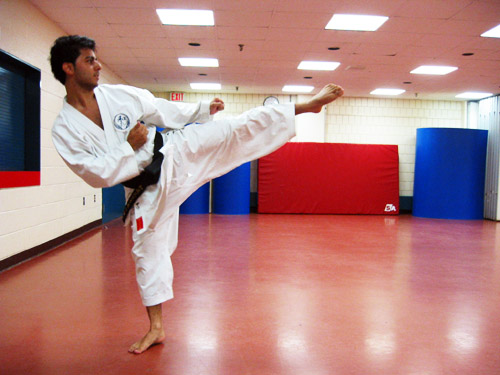 Ali doing some sort of Karate kick.