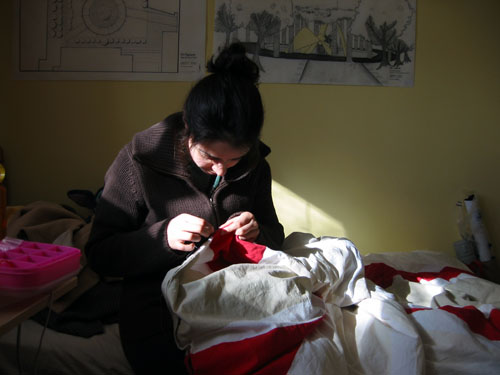 Shima sewing in her room.