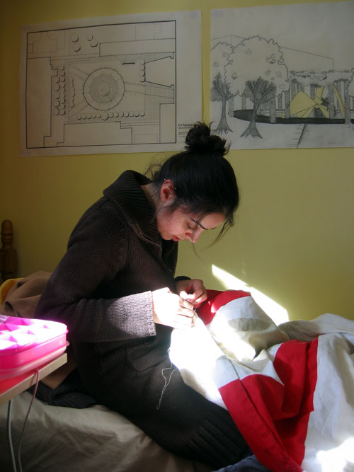 Shima still sewing in her room.