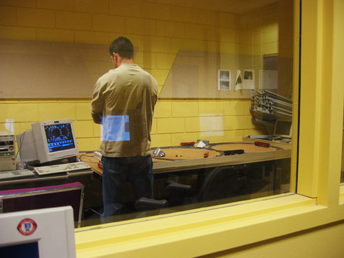 Matt stands alone in the train room, inside the real-time lab.