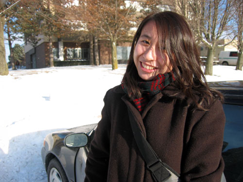 Tiffany standing beside her car outside of Eby Hall in Waterloo.