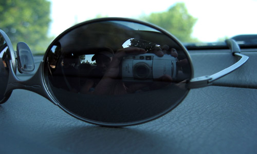 My Oakleys sitting on the dash of a car.