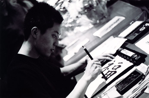 Toshi writing something in Japanese.