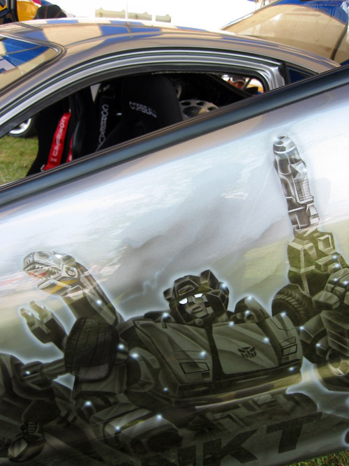 A car door painted with various Autobots.