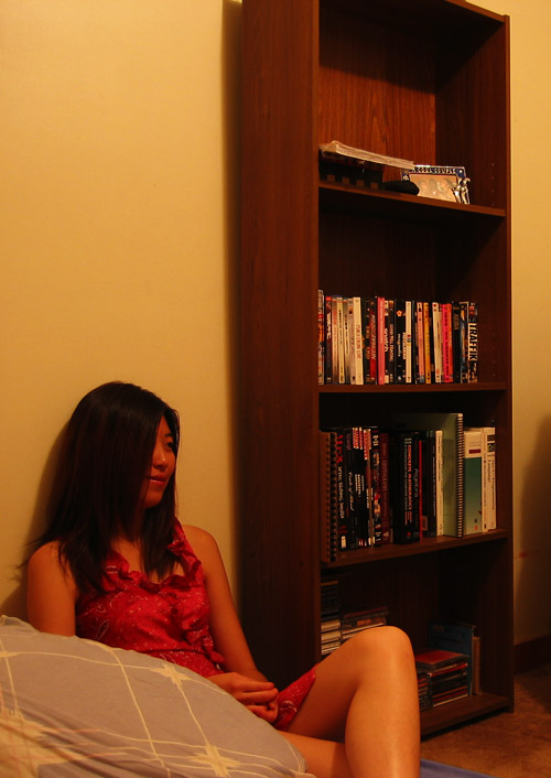 Yang sitting next to my bookshelf.