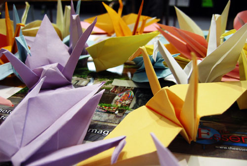 A few paper cranes on a table.