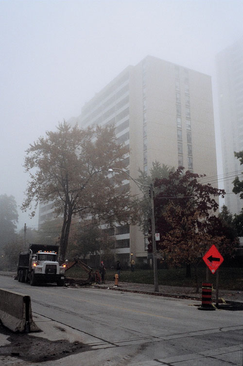 The apartment building I live in surrounded in fog.