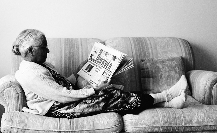 My grandmother sitting on the love seat in my living room.