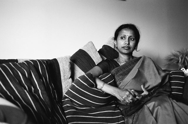 My mom sitting down in our living room.