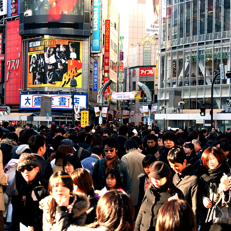 Pedestrians crossing the street in Hachiko-Mae Square, Shibuya.